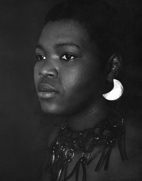 Sandy wearing her earrings and leather neckpiece. Her style is established as clean, sculptural and modern. An Ed Sherman photo.