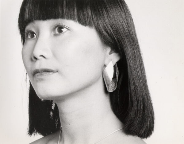 Model Irene wearing Sandy's Hugs Earrings. Bold sculptural earrings designed with the contours of the face in mind. A Shawn Walker photo.