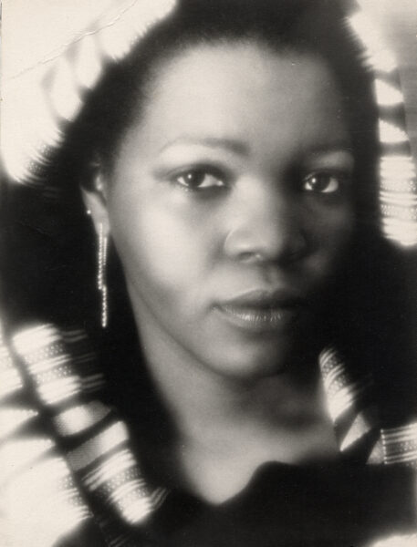 Sandy wearing her Scheherazade earring. The original photograph behind her National Jeweler feature.