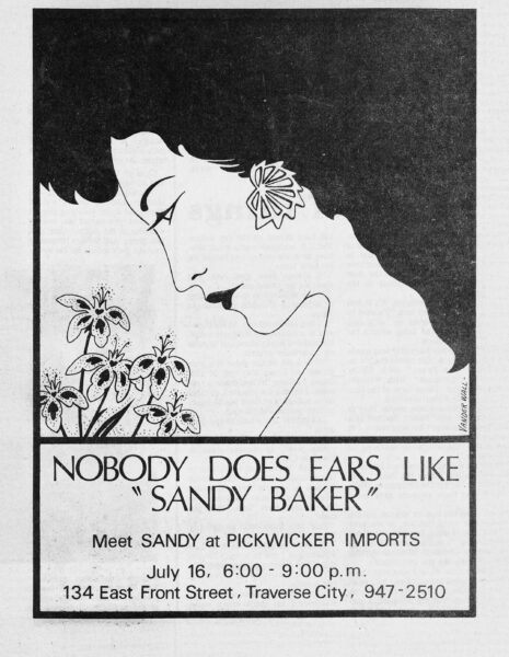 Nobody does ears like Sandy Baker. An ad for her appearance at Pickwicker Imports, 134 East Front Street, Traverse City, Michigan.