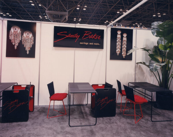 The Sandy Baker booth at a trade show, her work shown against black.