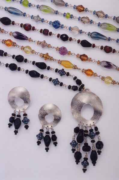 Sandy Baker's Wild Iris line, beaded strands worn with carved disc drops.