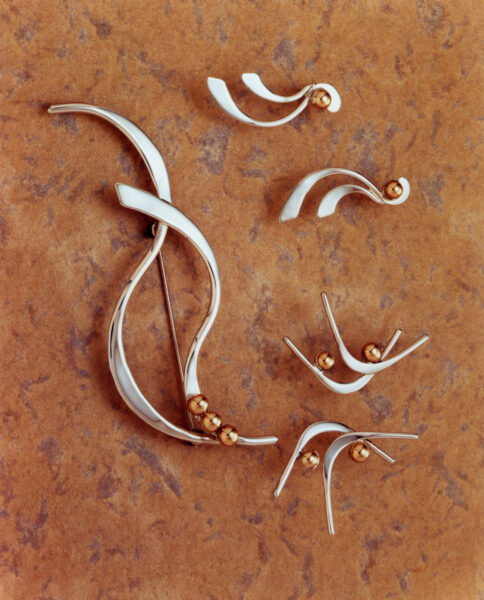 GRAND BASSAM Collection earrings, curved silver forms finished with gold beads.